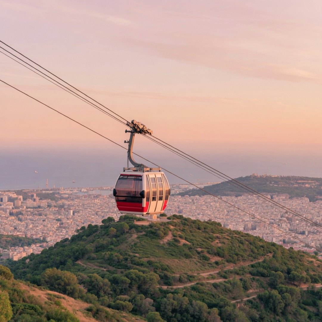 Cable car rising over Montjuïc hill with the city and sea below