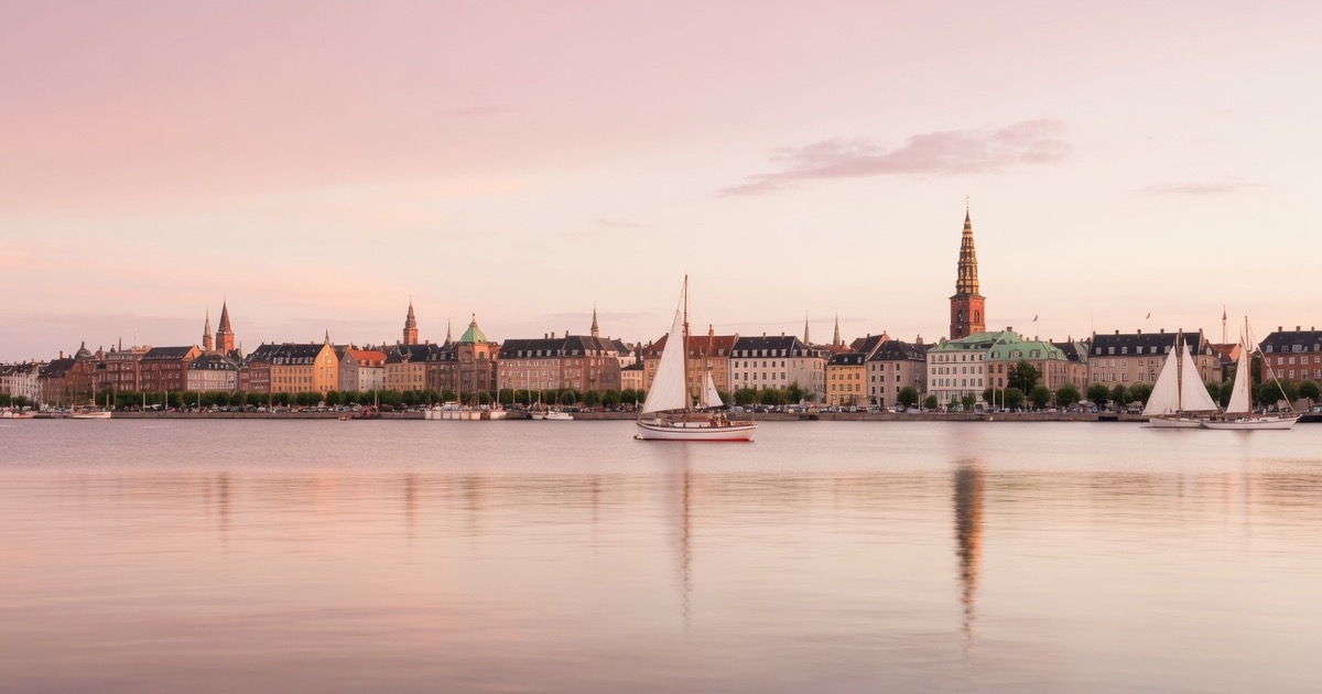 Copenhagen at dusk over the harbour with a city skyline and calm water