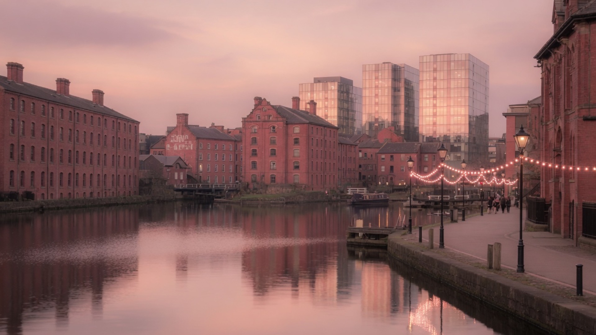 Canal basin and brick viaducts at dusk in Manchester