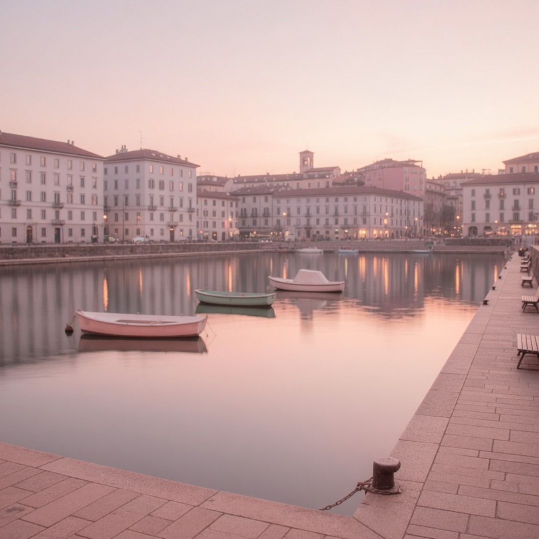 The wide Darsena basin reflecting the Milan skyline at dusk