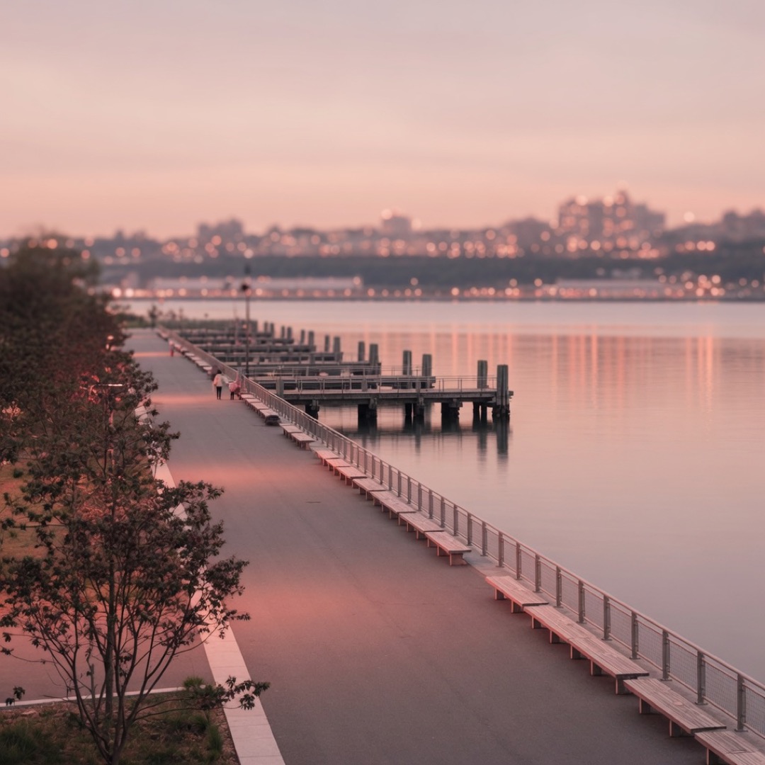 Paved path along Hudson River Park with piers